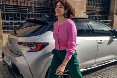 Woman walking past Corolla
