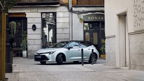 man approaching grey Toyota Corolla Hatchback