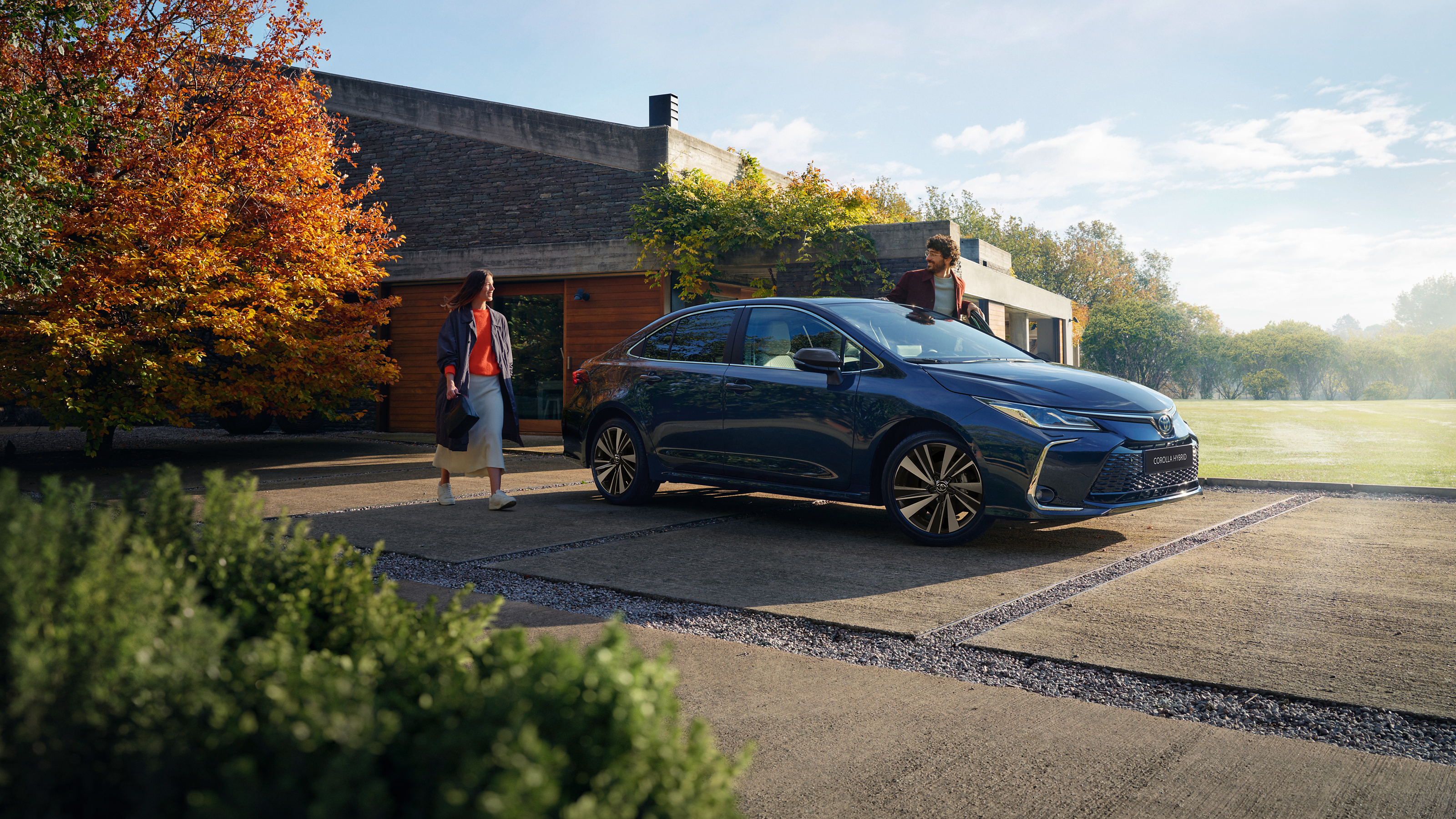 A Toyota Corolla Sedan drives through the city 