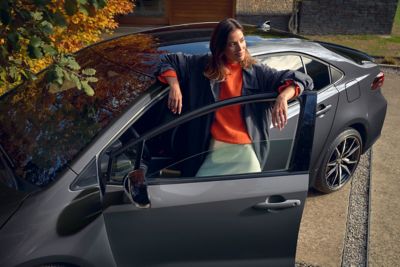 woman with toyota corolla saloon 