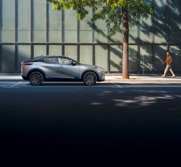 A Toyota C-HR+ parked on a sunny city street