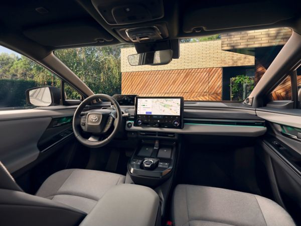 The front seats and sleek dashboard of the Toyota C-HR+