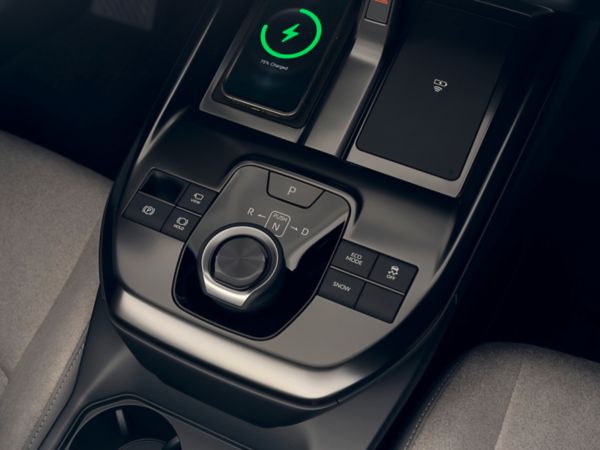 The driving controls and dual wireless phone chargers of the Toyota C-HR+ 