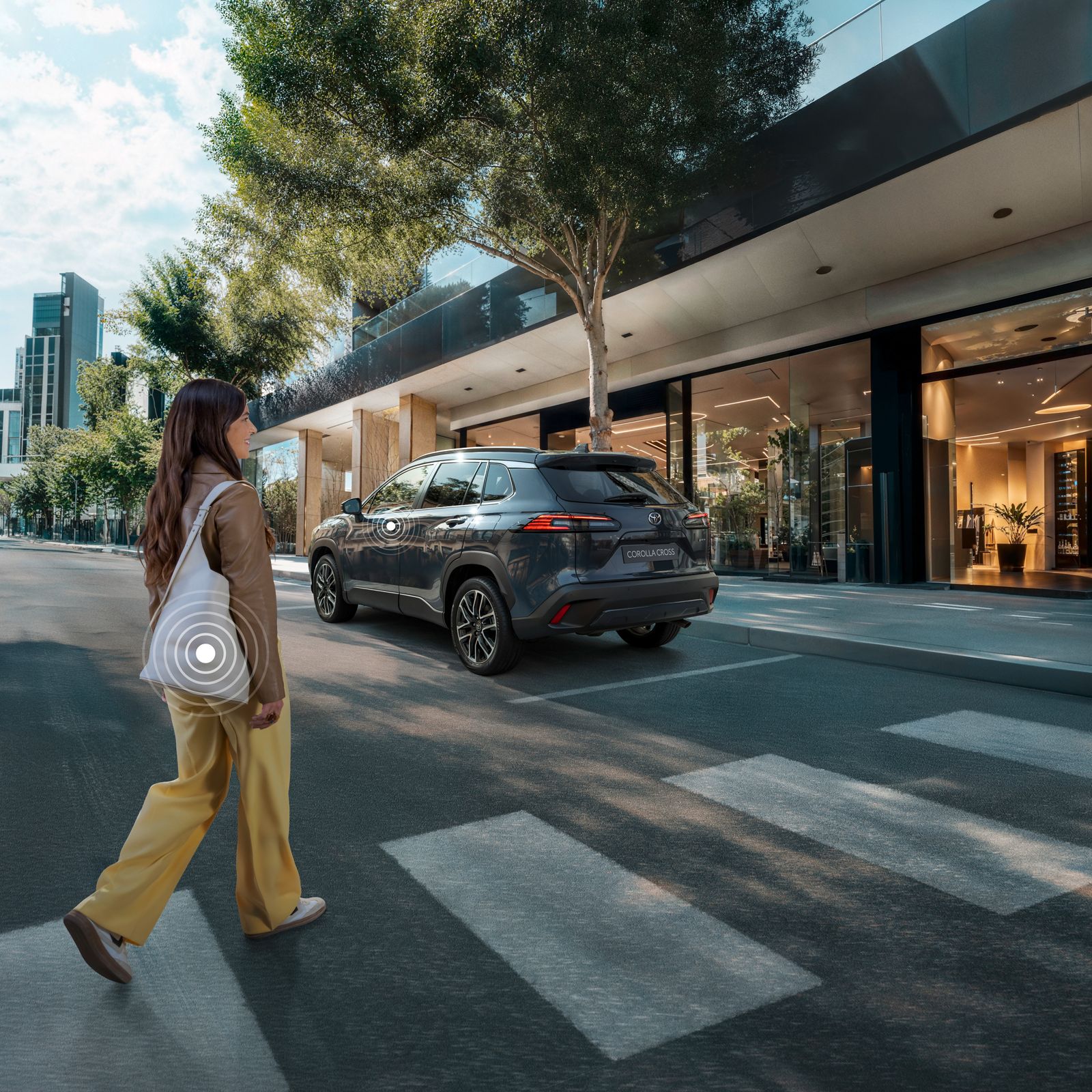 A Toyota Corolla Cross owner crosses the street while activating their Smart Digital Key