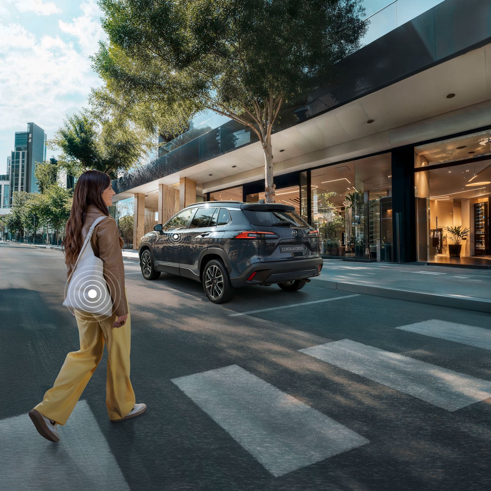 A Toyota Corolla Cross owner crosses the street while activating their Smart Digital Key
