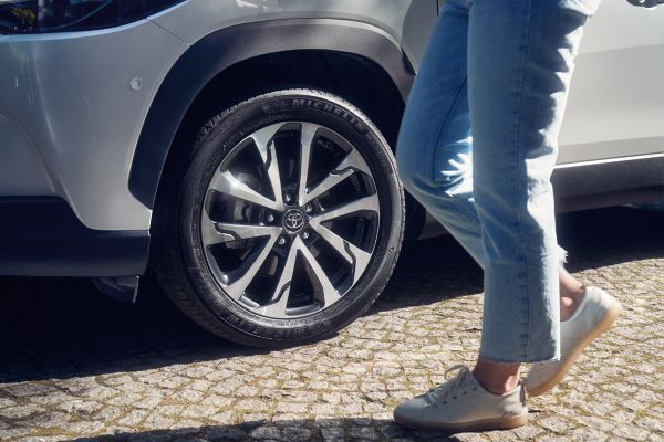 person walking by a Toyota car