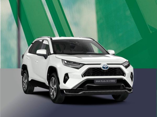 Ein weißer Toyota RAV4 Plug-in Hybrid steht frontal leicht von links fotografiert vor einem grünem Hintergrund.