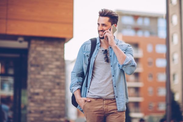 Man walking with phone in city