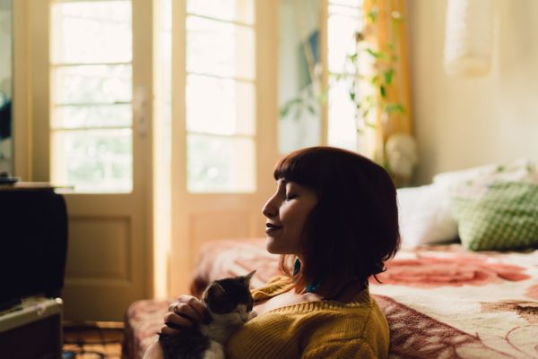 Woman smiling while holding a cat