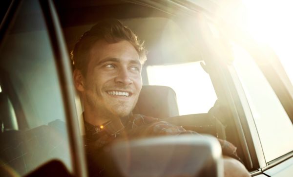 Man smiling while driving