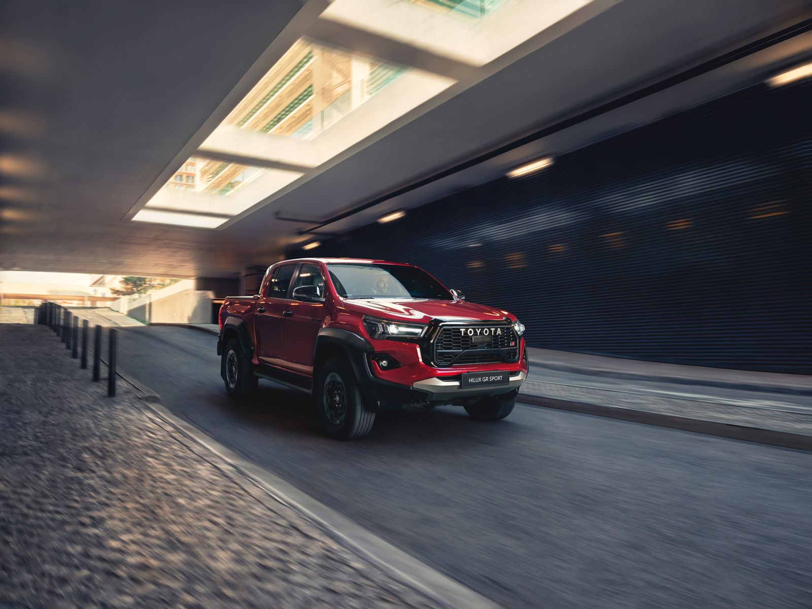 Hilux drives along an urban underpass