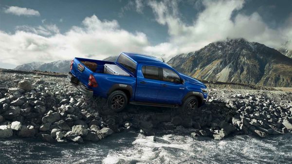 Toyota Hilux driving on the side of a mountain