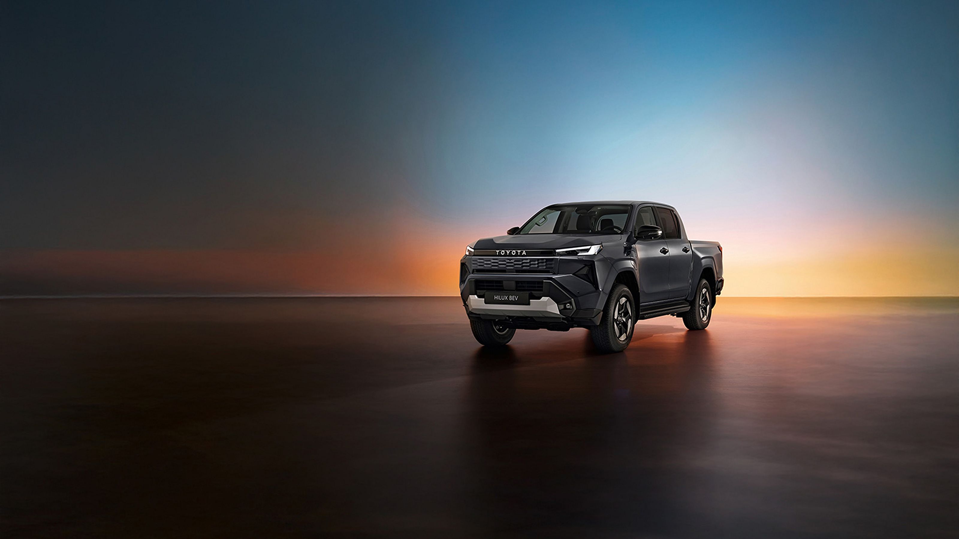 Nouvelle Toyota Hilux avec un couché de soleil en arrière-plan.