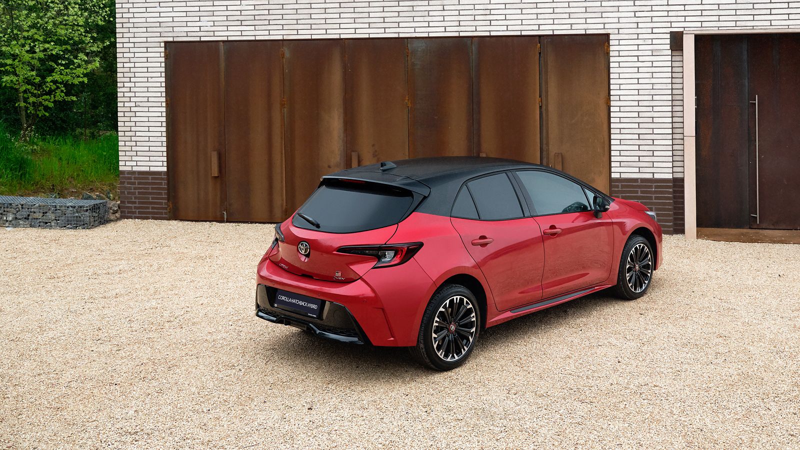 An owner opens one of their Toyota Corolla Hatchback’s rear doors