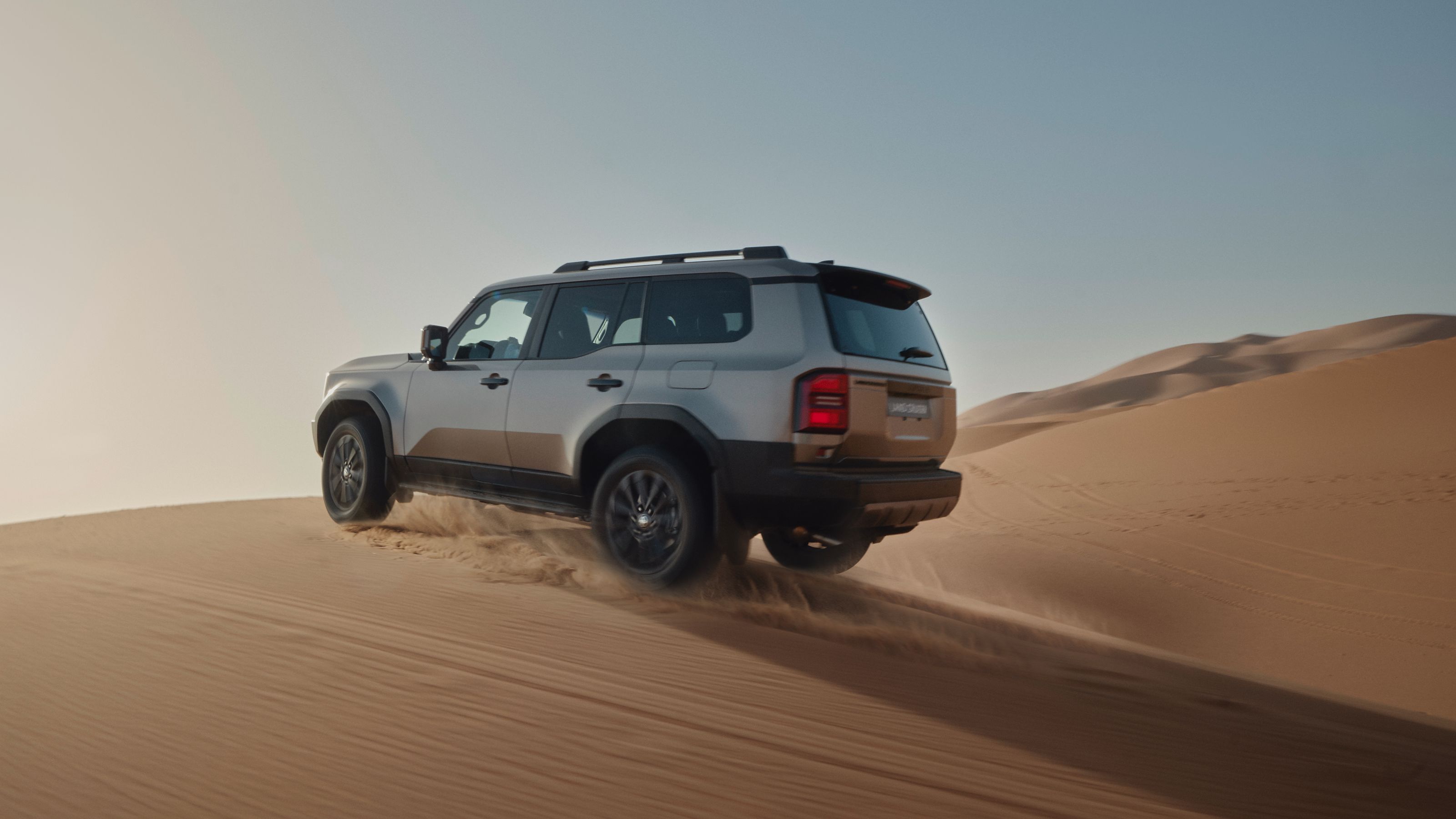 A Land Cruiser driving through the desert
