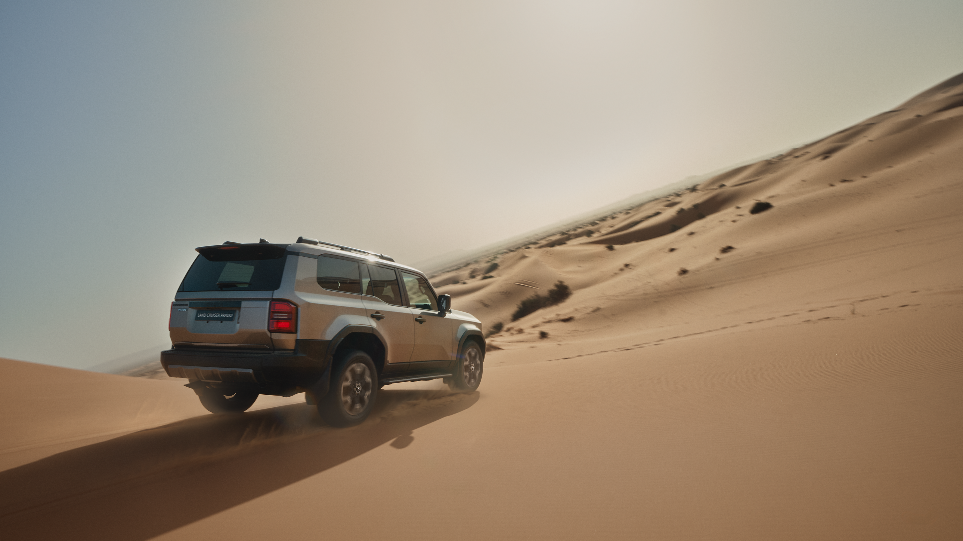 Land Cruiser fitted with rear lower trunk garnish & 20" alloy wheels parked in the desert