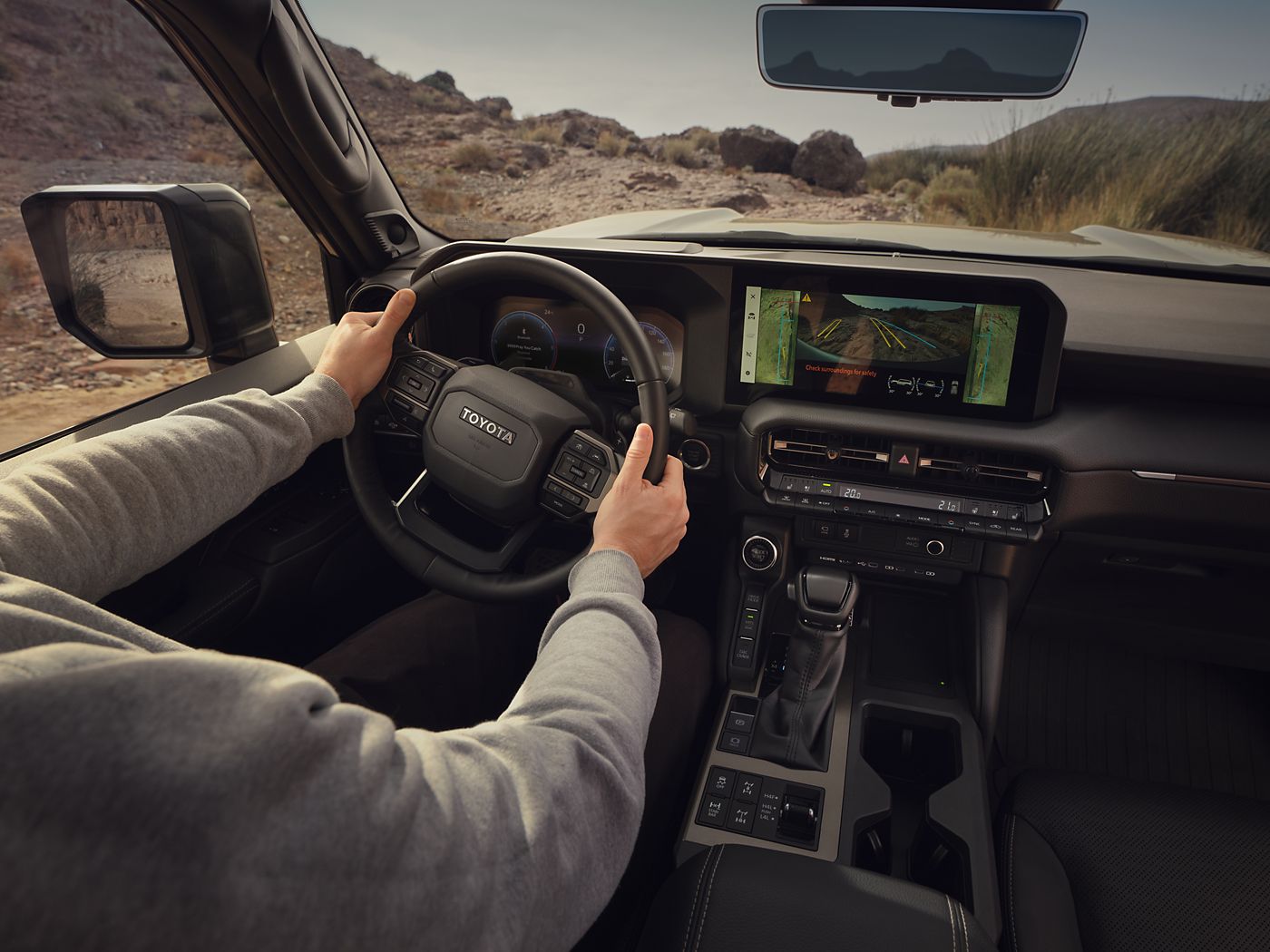 Land Cruiser drives through a desert environment