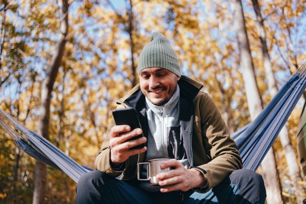 Man checking phone outside