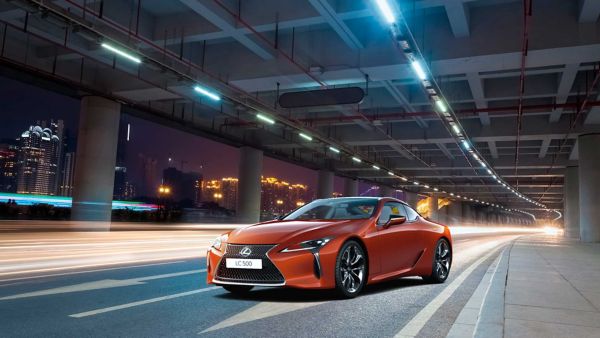 Lexus LC and LC Convertible parked in front of a racetrack 