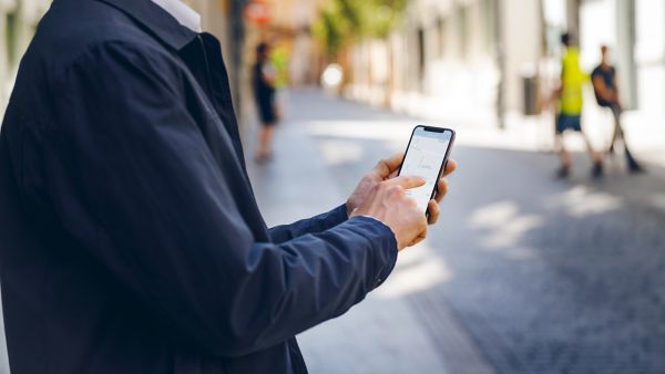 man pointing at his phone