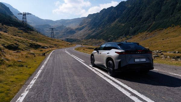 Lexus RZ rijdt over een weg