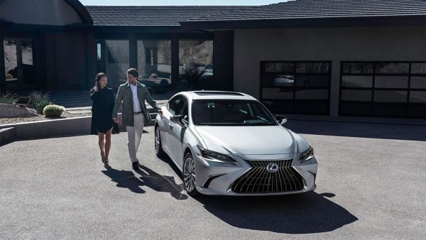 A man and woman approaching a Lexus ES 
