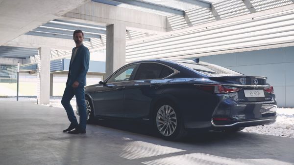 man standing next to a Lexus ES 300h