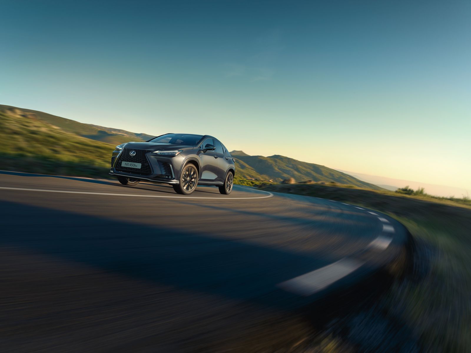 Rear view of a Lexus NX driving on a coastal road