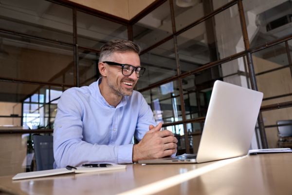 Man smiling on laptop