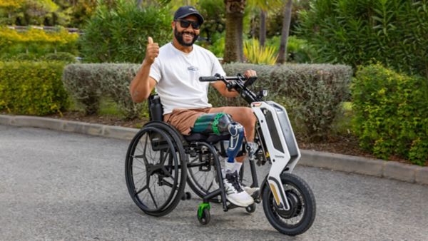 Retrofitted hydrogen bus with Toyota Global Team Athletes on the side and the slogan 'Start Your Impossible'