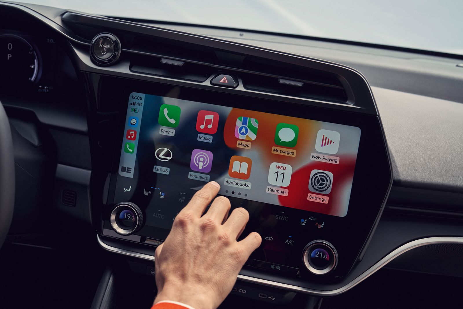 A person interacting with the multimedia display of a Lexus RZ 