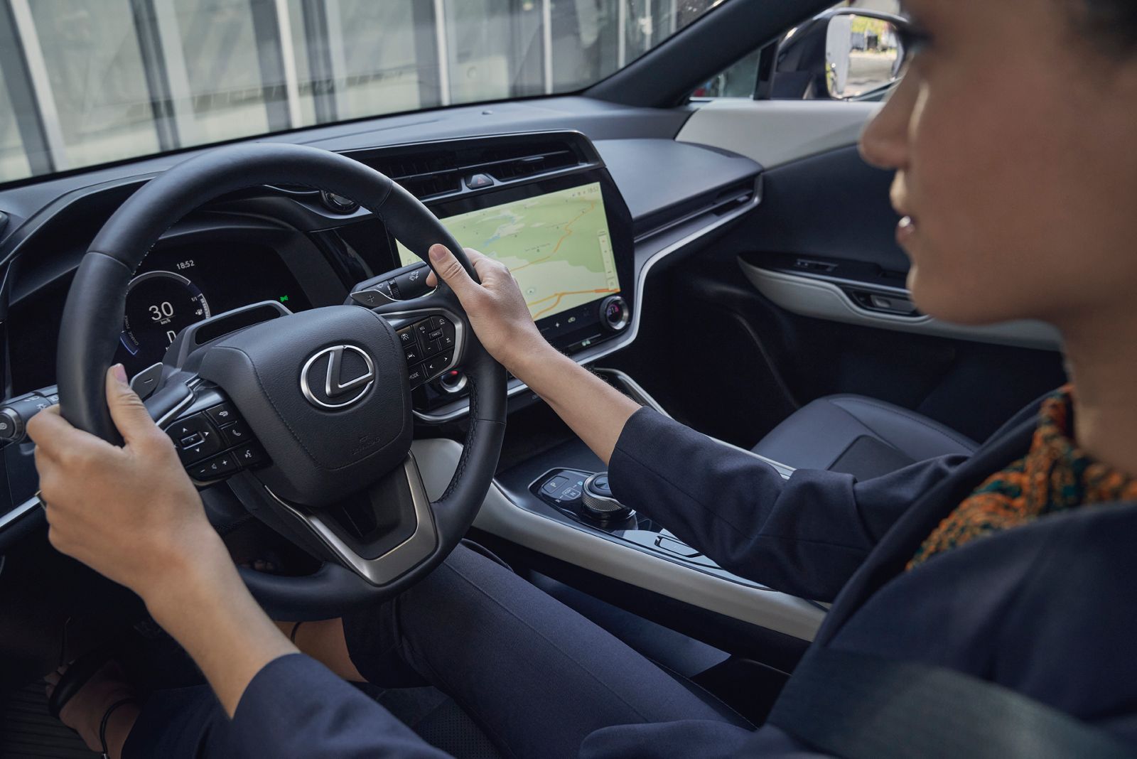 A person in the cockpit of a Lexus RZ