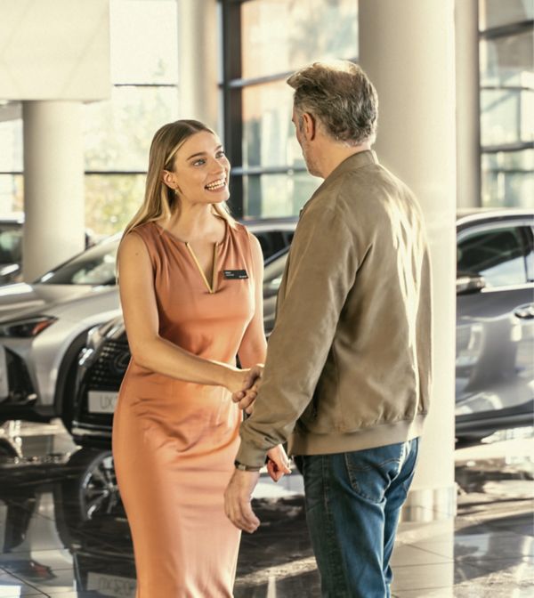 two people shaking hands in a Lexus centre