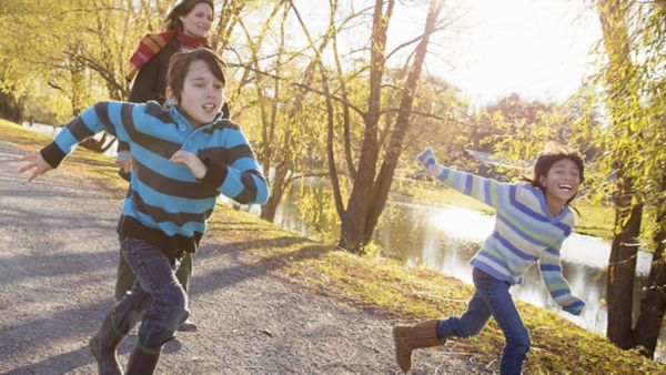 Jeunes femmes avec deux enfants courant librement 