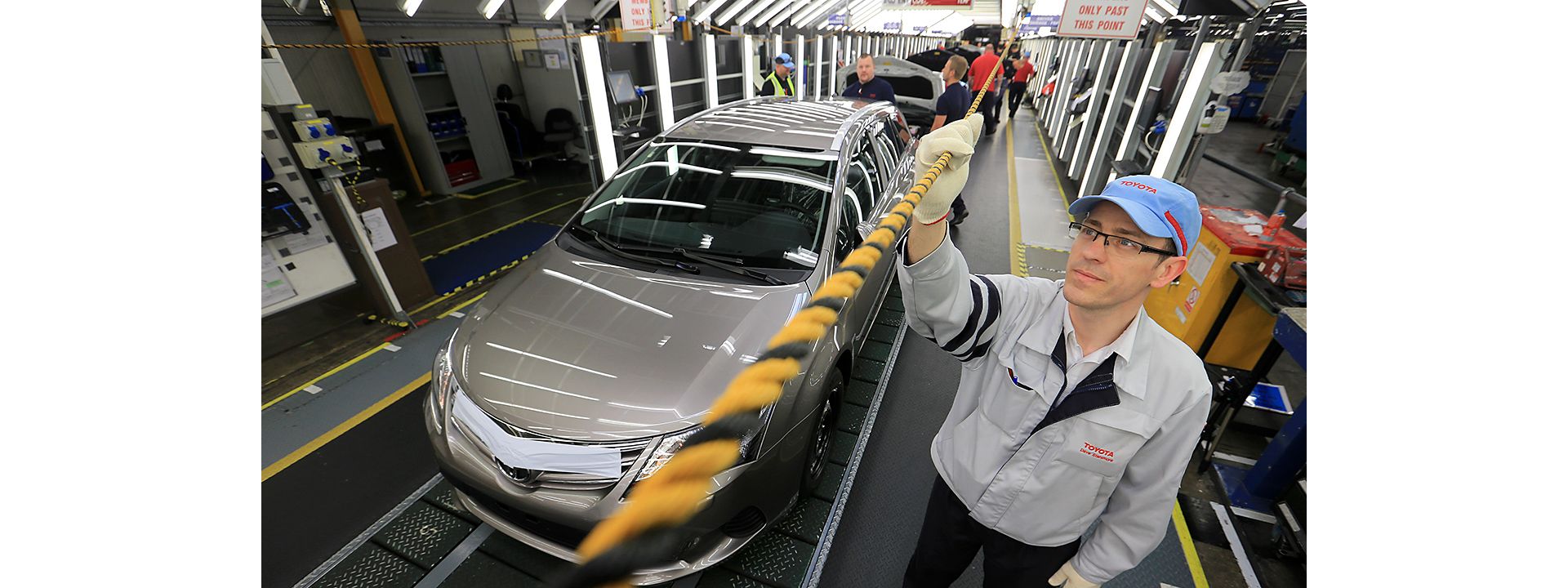 Toyota factory worker holding andon rope