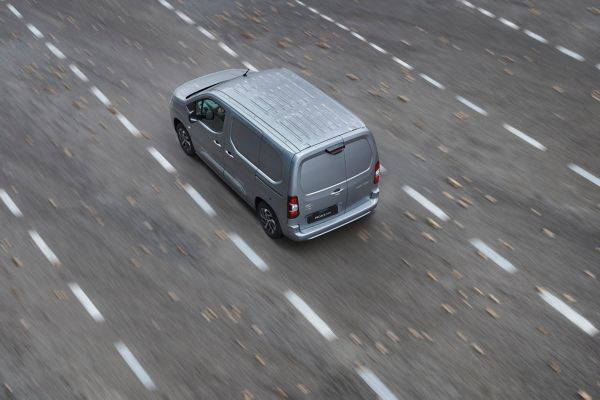 A Toyota Proace drives a long country road