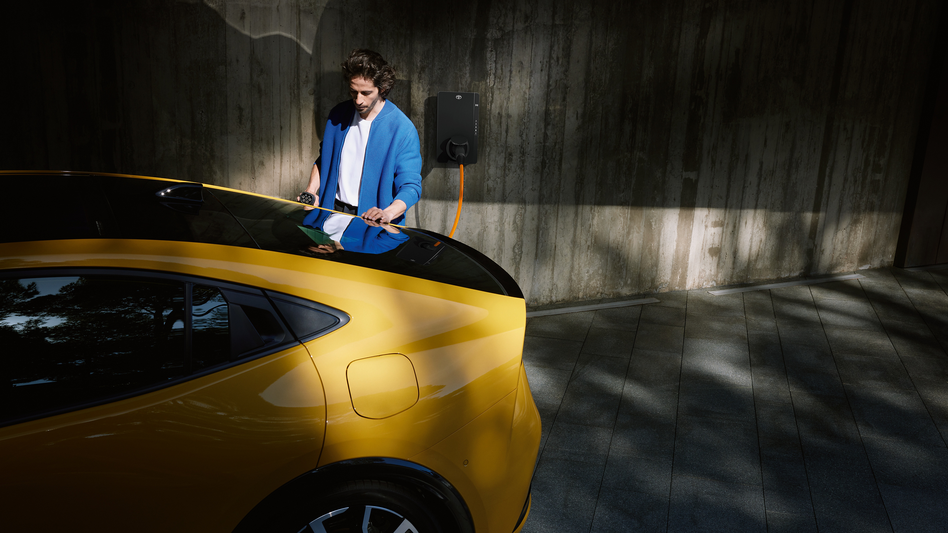 Man charging Toyota Prius Plug-in