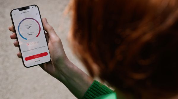 An owner remotely preconditions their cabin temperature using the MyToyota app