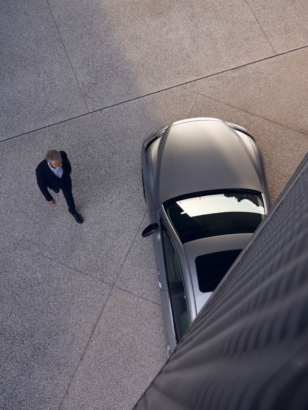 A person standing next to a Lexus LC Convertible