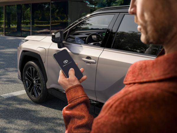 A Toyota RAV4 owner uses the MyToyota app on their smartphone