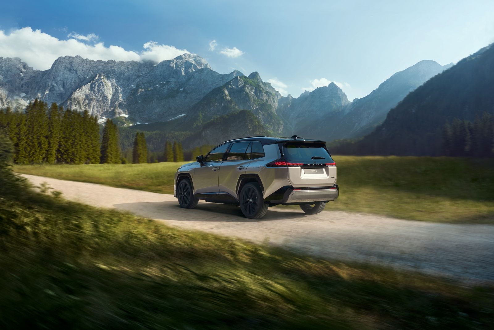RAV4 Plug-in Hybrid driving down a dirt road in the mountains