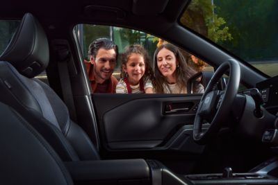 Family looking inside Toyota RAV4