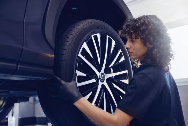 A Lexus mechanic working on a Lexus wheel