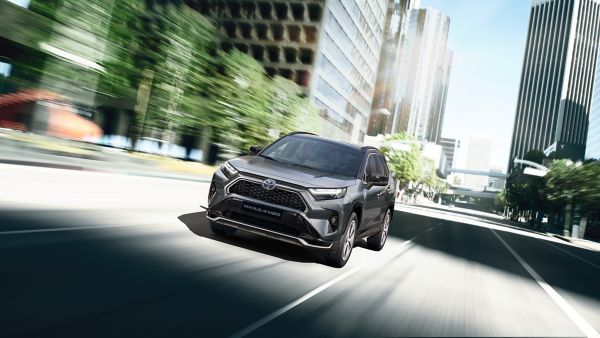 Toyota RAV4 Plug-in hybrid driving down a road