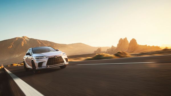 woman walking past a Lexus car