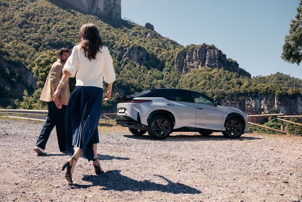 two people approaching a Lexus car