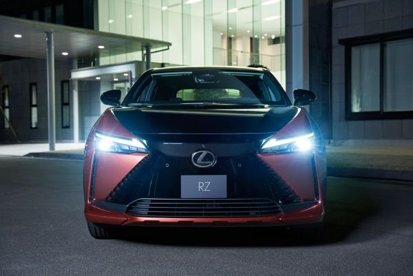 Front view of a Lexus RZ with the headlights on