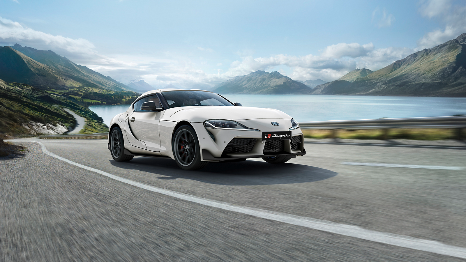 GR Supra drives past a lake
