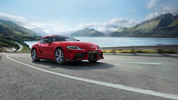 Toyota Supra driving along a road