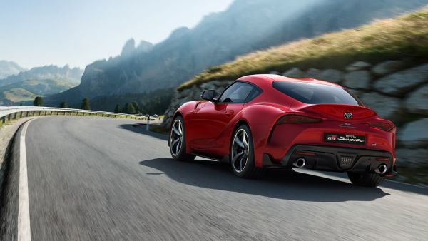 Toyota Supra driving along a road